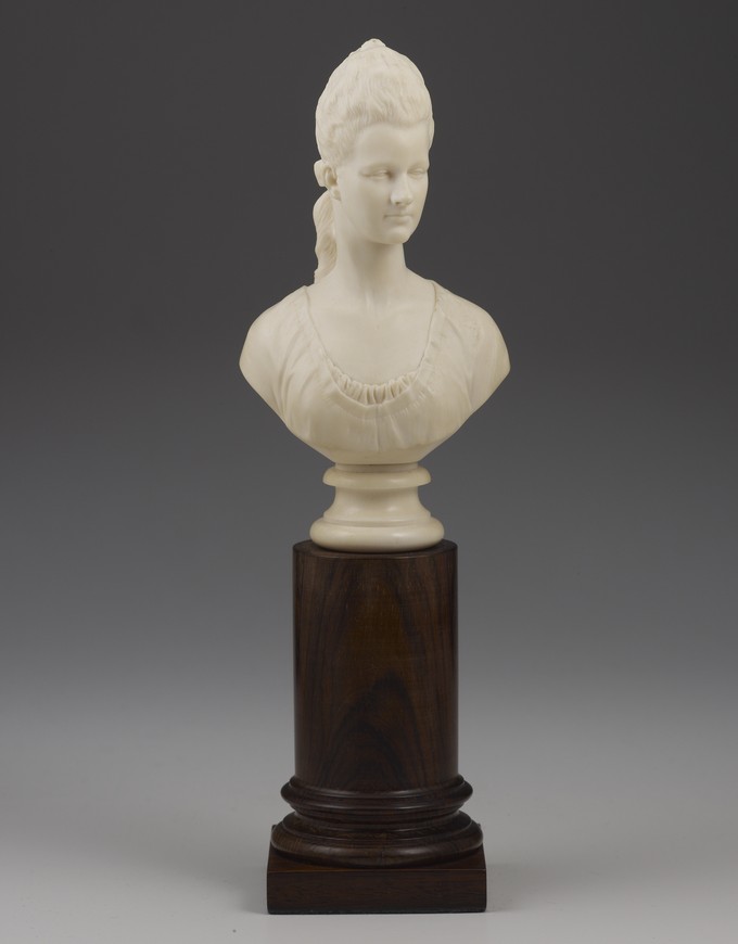 Bust of a Woman wearing a long woven pony tail with ribbon