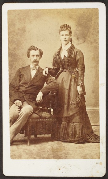 Unknown sitters [portrait of a seated man and standing woman, with her right hand on man's left shoulder]