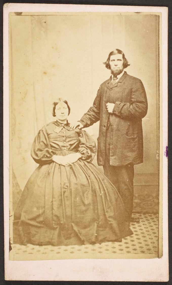Unknown sitters  [portrait of a seated woman and standing man, with his right hand on woman's left shoulder]