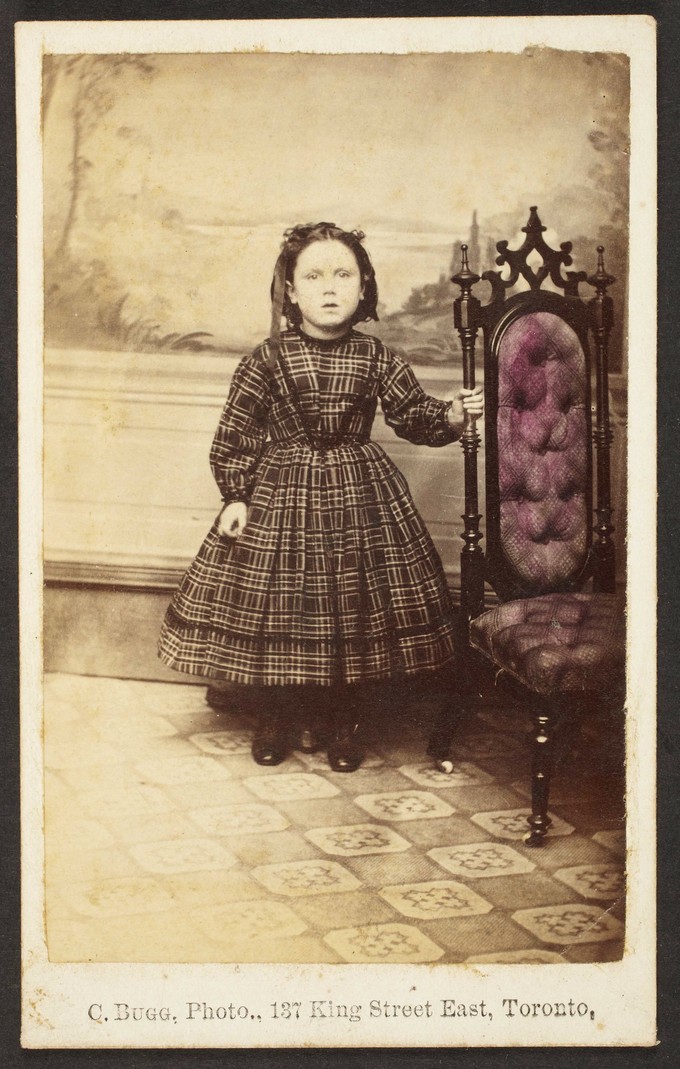 Unknown sitter [portrait of a standing girl holding on to an upholstered chair]