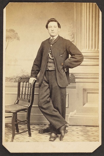 Unknown sitter [portrait of a standing man with a chair]