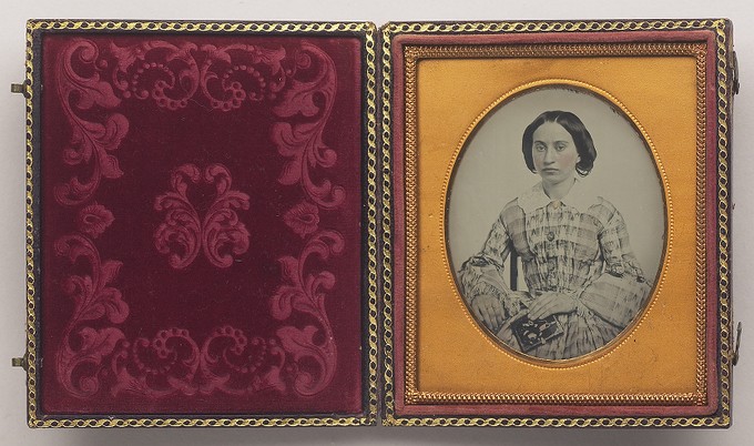 [Young Woman Holding Photograph]